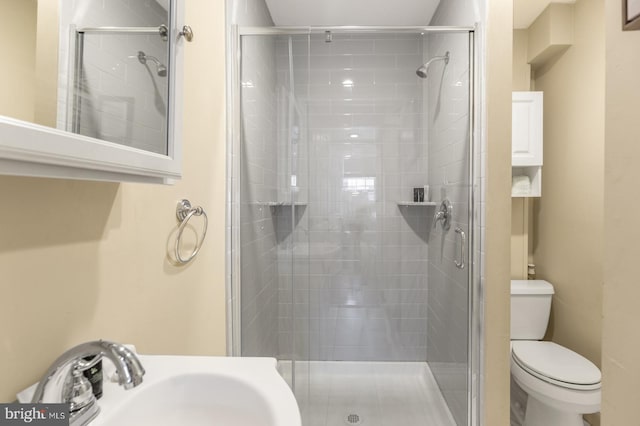 bathroom with sink, toilet, and walk in shower