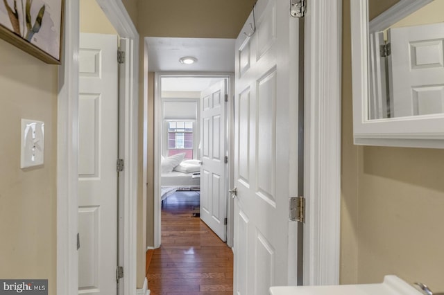 hallway with hardwood / wood-style floors