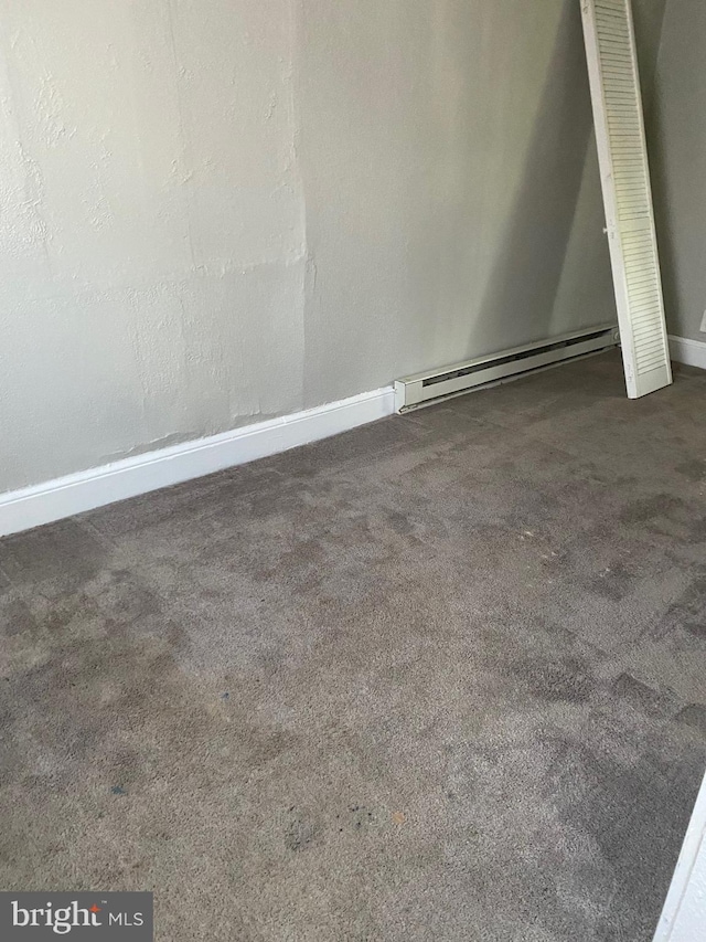 interior space with a baseboard radiator and carpet floors