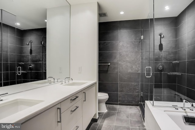 full bathroom featuring toilet, tile walls, separate shower and tub, double sink vanity, and tile patterned floors