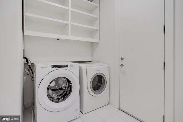 washroom featuring light tile patterned floors and separate washer and dryer