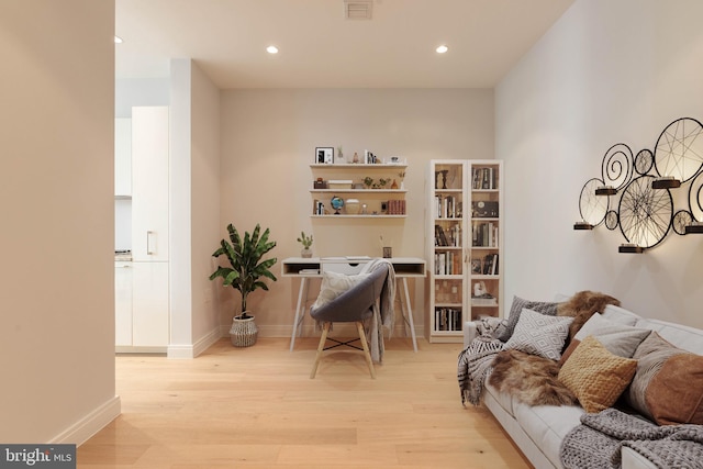 office area with light hardwood / wood-style floors