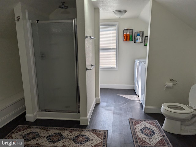 bathroom featuring lofted ceiling, a shower with shower door, wood-type flooring, and toilet