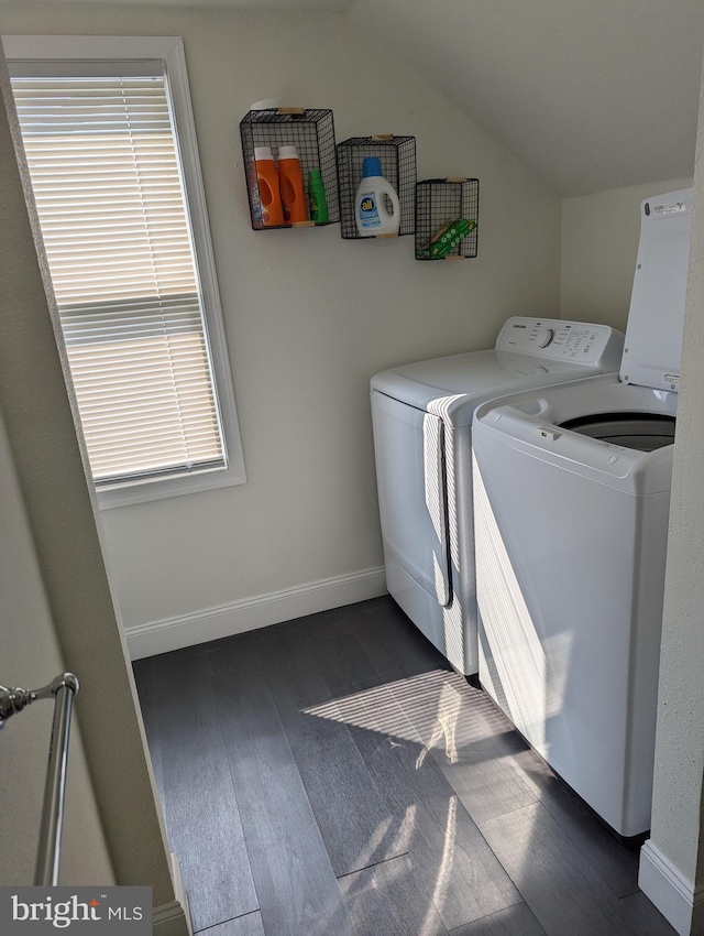 clothes washing area featuring dark hardwood / wood-style floors and washer and clothes dryer