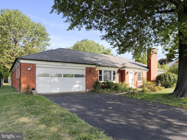 single story home featuring a garage and a front yard