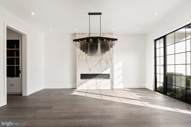 unfurnished living room with hardwood / wood-style flooring and a fireplace