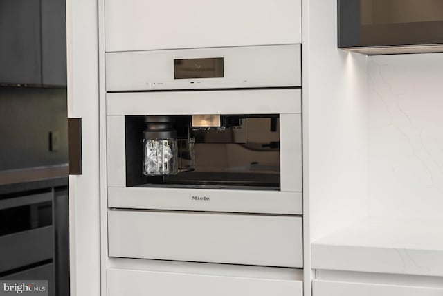 interior details with white oven and tasteful backsplash