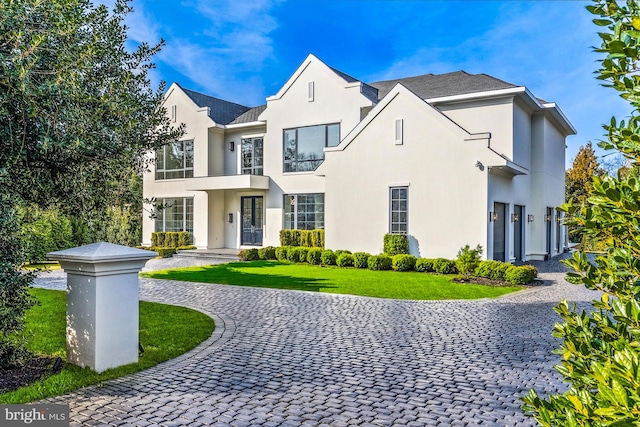 view of front of home featuring a garage and a front lawn