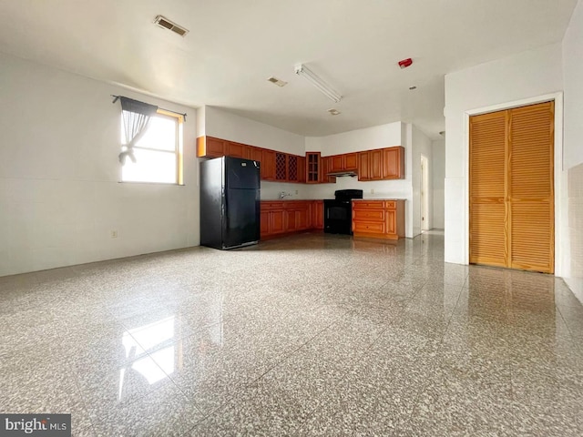 kitchen featuring range and black fridge