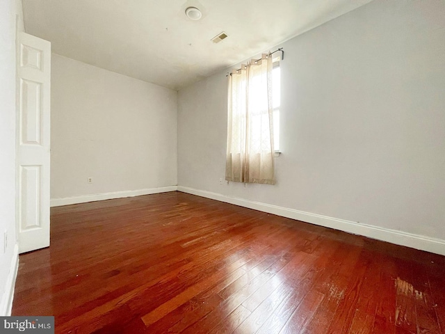 spare room with wood-type flooring