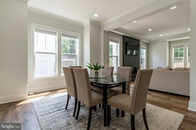 dining space featuring ornamental molding, recessed lighting, baseboards, and wood finished floors