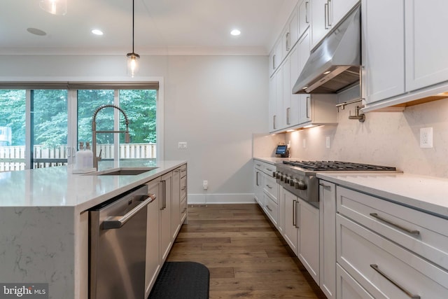 kitchen featuring decorative backsplash, appliances with stainless steel finishes, under cabinet range hood, white cabinetry, and a sink