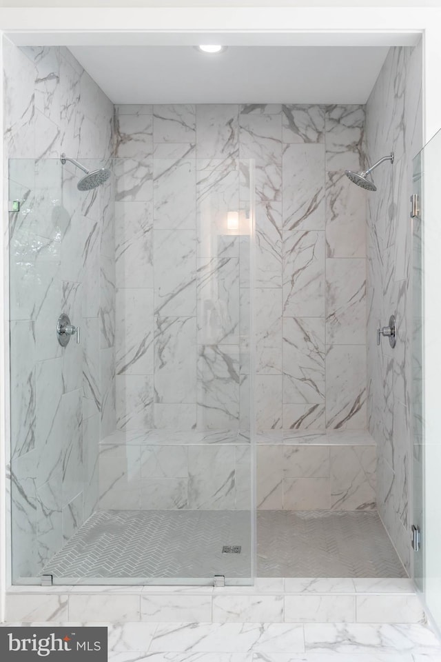 full bathroom with a marble finish shower