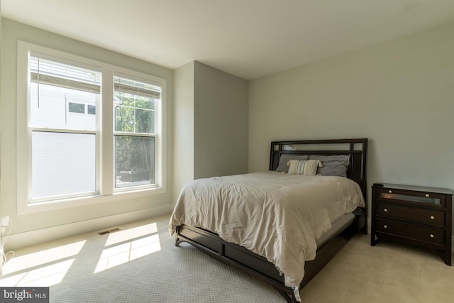 bedroom featuring light carpet and visible vents