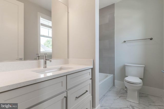 bathroom with marble finish floor, toilet, vanity, and baseboards