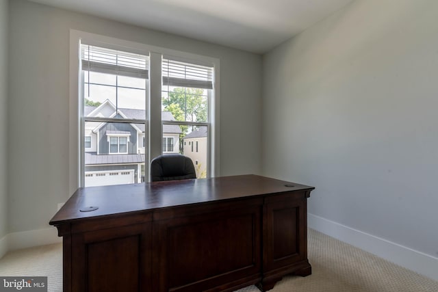 office space with light carpet and baseboards