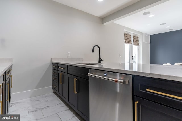 kitchen featuring marble finish floor, a sink, dark cabinetry, dishwasher, and baseboards