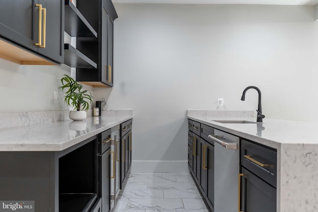 kitchen with light stone counters, a sink, baseboards, marble finish floor, and open shelves