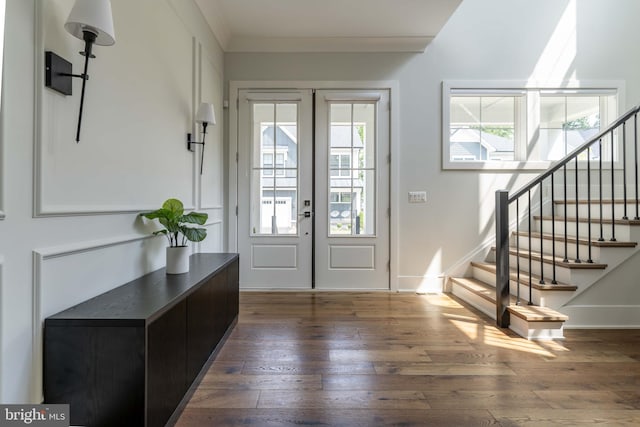 entrance foyer with french doors, dark wood-style flooring, stairway, ornamental molding, and baseboards