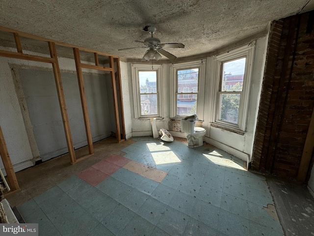 interior space with ceiling fan