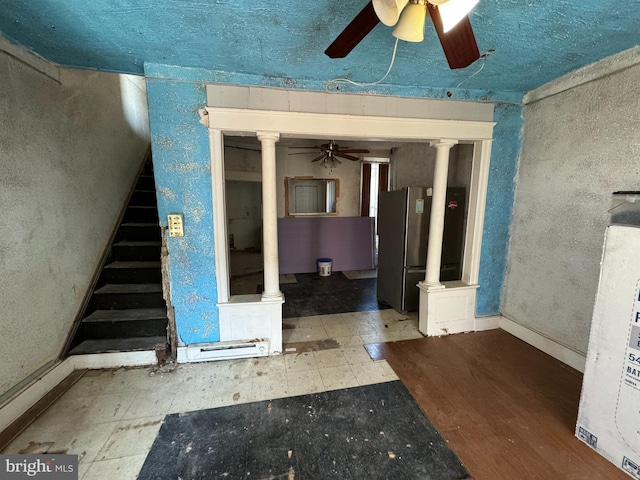 entrance foyer with ceiling fan and ornate columns