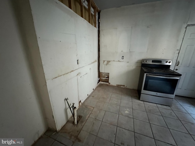 kitchen with stainless steel electric range oven and light tile patterned floors