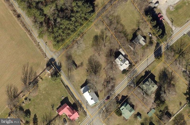 birds eye view of property with a rural view