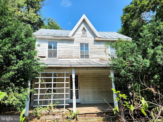 rear view of property featuring a porch