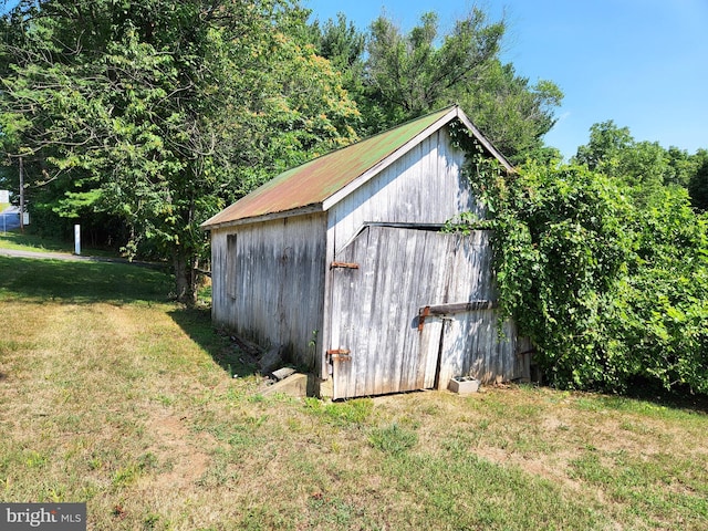 view of outbuilding with a lawn