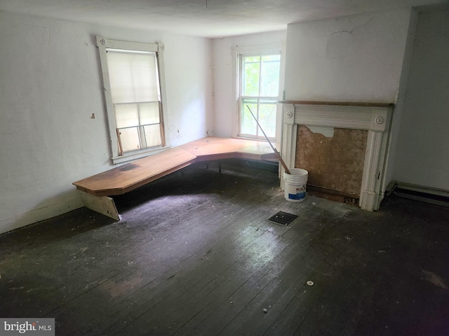 unfurnished living room featuring hardwood / wood-style floors