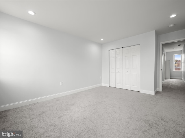 unfurnished bedroom with carpet floors, baseboards, a closet, and recessed lighting