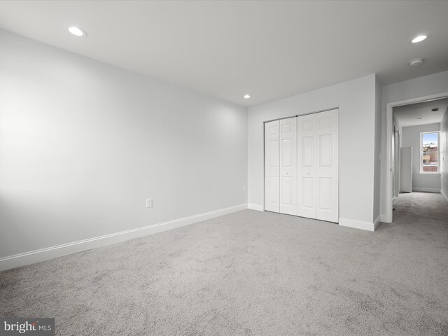 unfurnished bedroom with a closet and carpet flooring