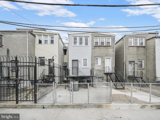 view of property featuring a fenced front yard, a gate, and stucco siding