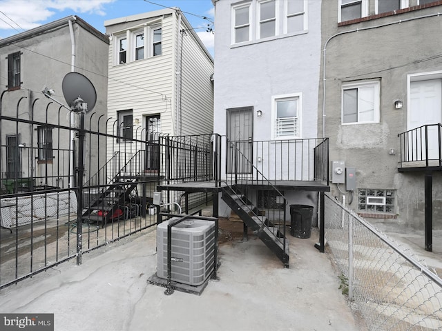 view of patio featuring central AC unit and fence