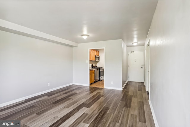 unfurnished living room featuring dark hardwood / wood-style flooring