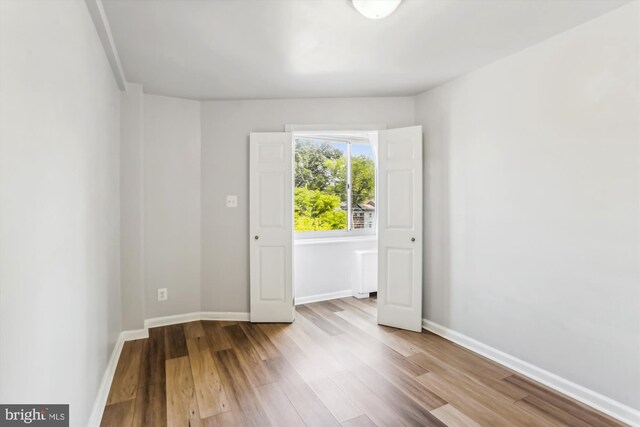 empty room with light hardwood / wood-style flooring