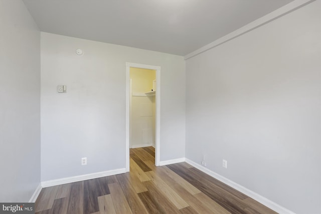 empty room with hardwood / wood-style flooring