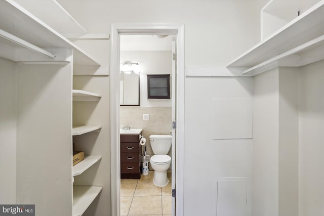 walk in closet featuring light tile patterned floors and sink