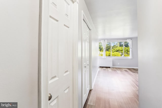 corridor with light hardwood / wood-style floors