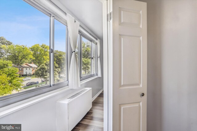 interior space with hardwood / wood-style flooring and radiator