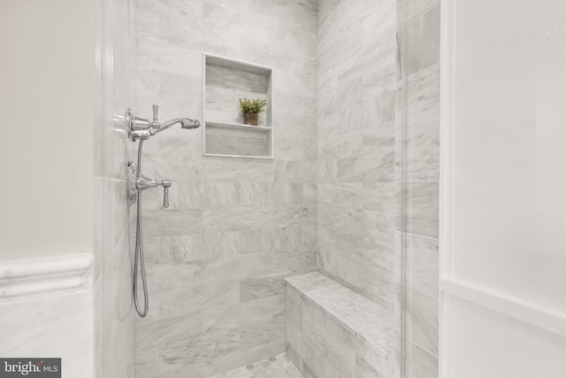 full bath with a tile shower