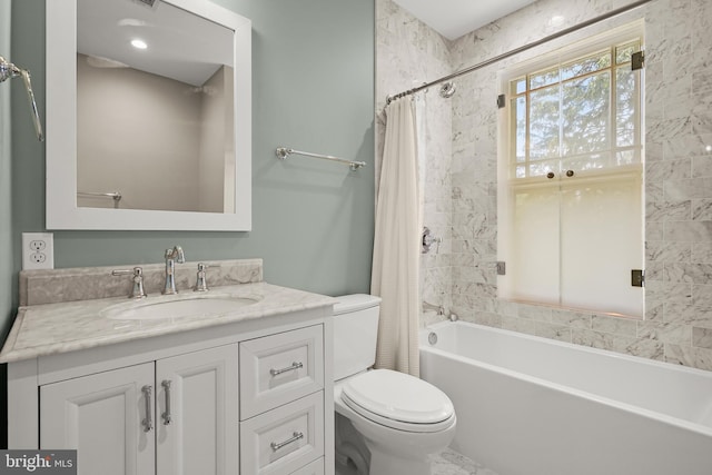 bathroom with vanity, toilet, and shower / bath combo with shower curtain