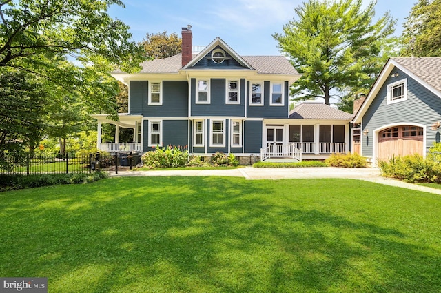 view of front of house with a porch, a front yard, fence, and a chimney