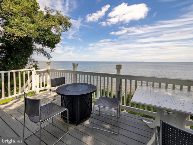 back of house featuring a patio, an outdoor fire pit, a deck, and a balcony