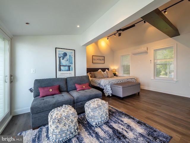 bedroom with a wall mounted AC, vaulted ceiling, dark wood-type flooring, and rail lighting