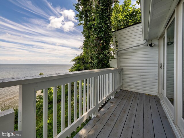 wooden deck featuring a water view