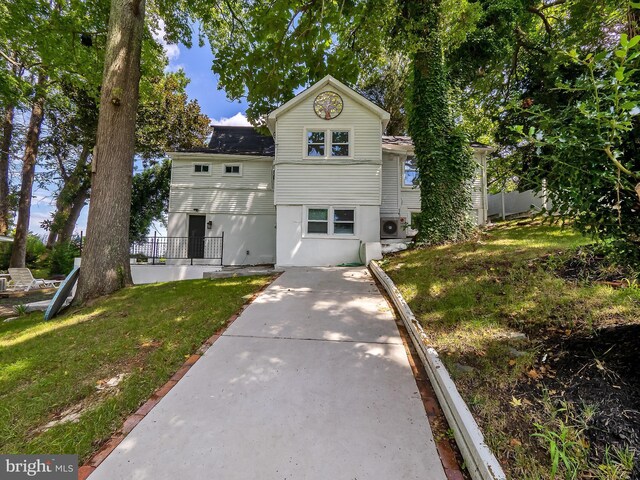 back of house featuring a deck, a balcony, and a yard