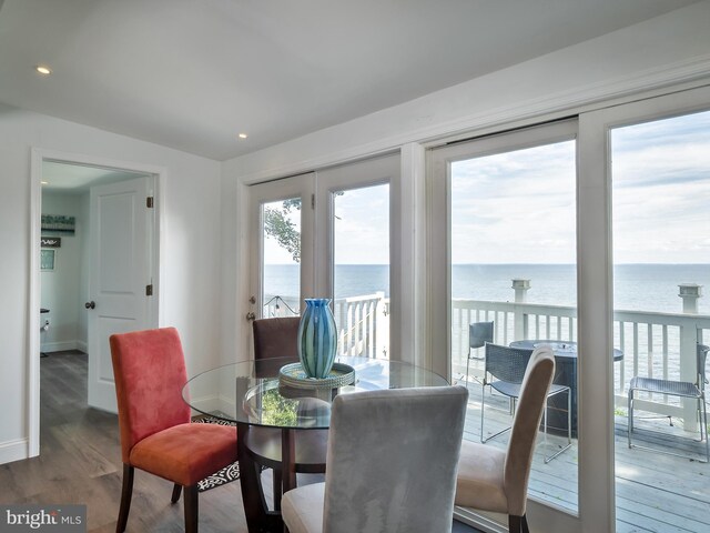 wooden terrace with a water view and a storage unit