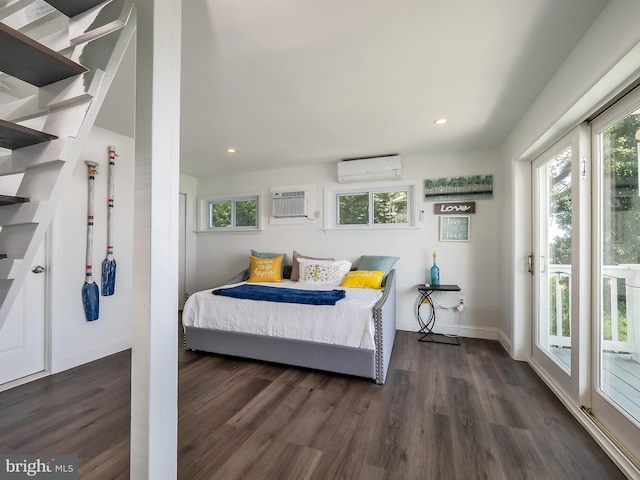 bedroom featuring access to outside, dark hardwood / wood-style floors, and a wall mounted AC