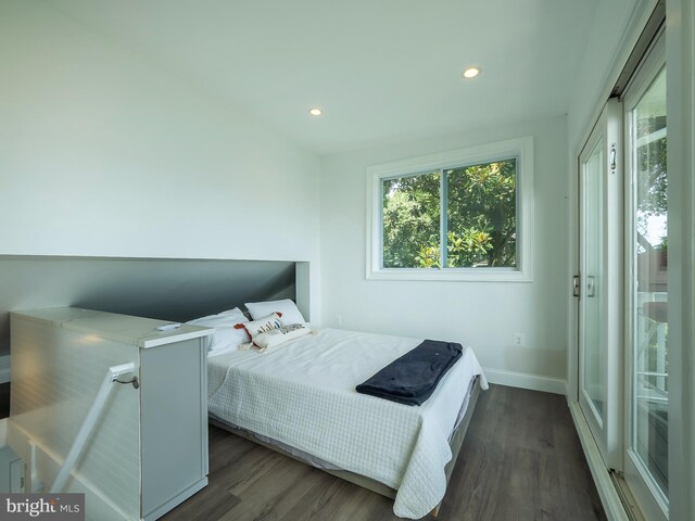 bedroom with dark wood-type flooring